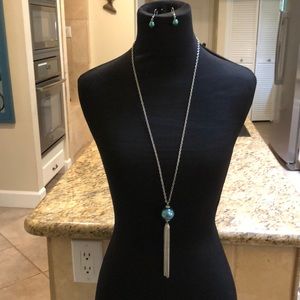 Long silver tone 21” drop necklace with blue ball and matching earrings.